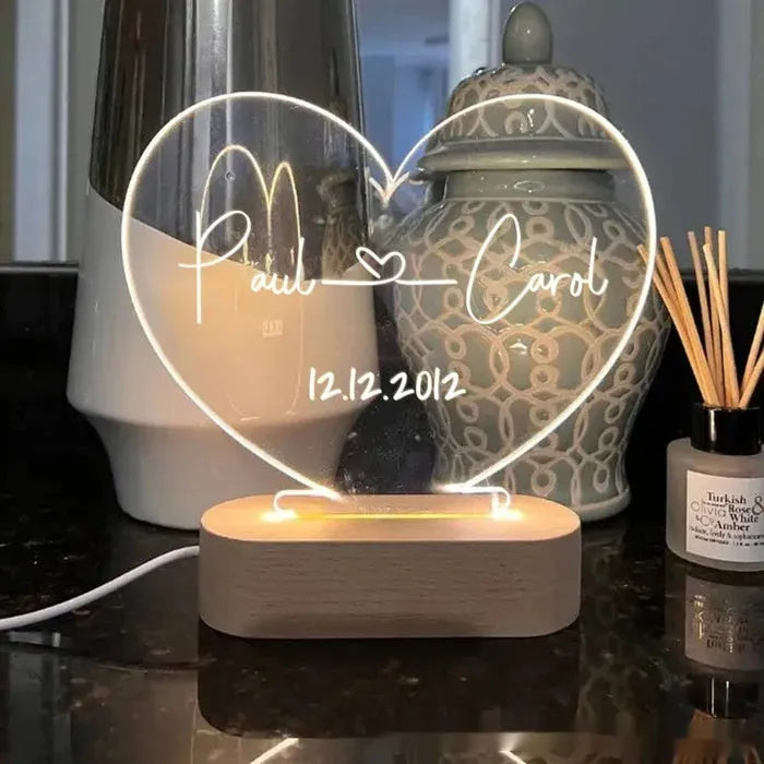 Custom transparent acrylic LED night light with personalised names and date engraving.