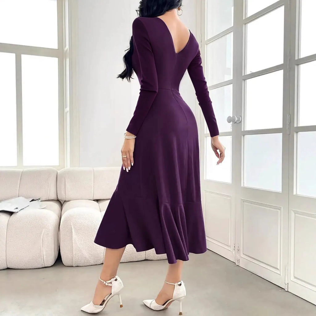 A purple women's long sleeve dress with ruffles and a round neck, shown on a hanger.
