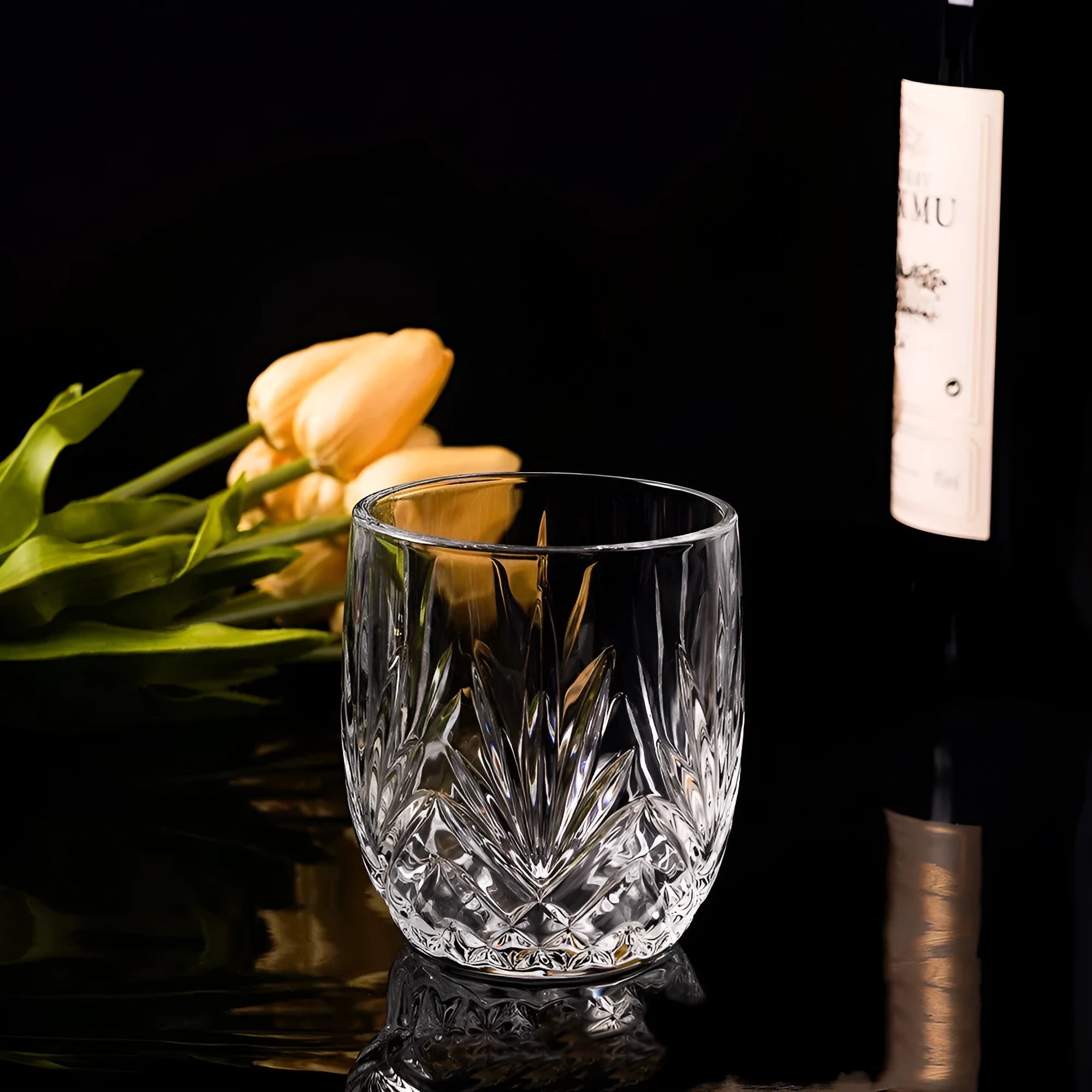 Clear crystal whiskey shot glass with a thick, heavy base on a table.