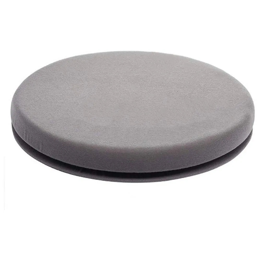 A grey rotating car seat cushion on a car seat, showing its non-slip base and plush fabric texture.