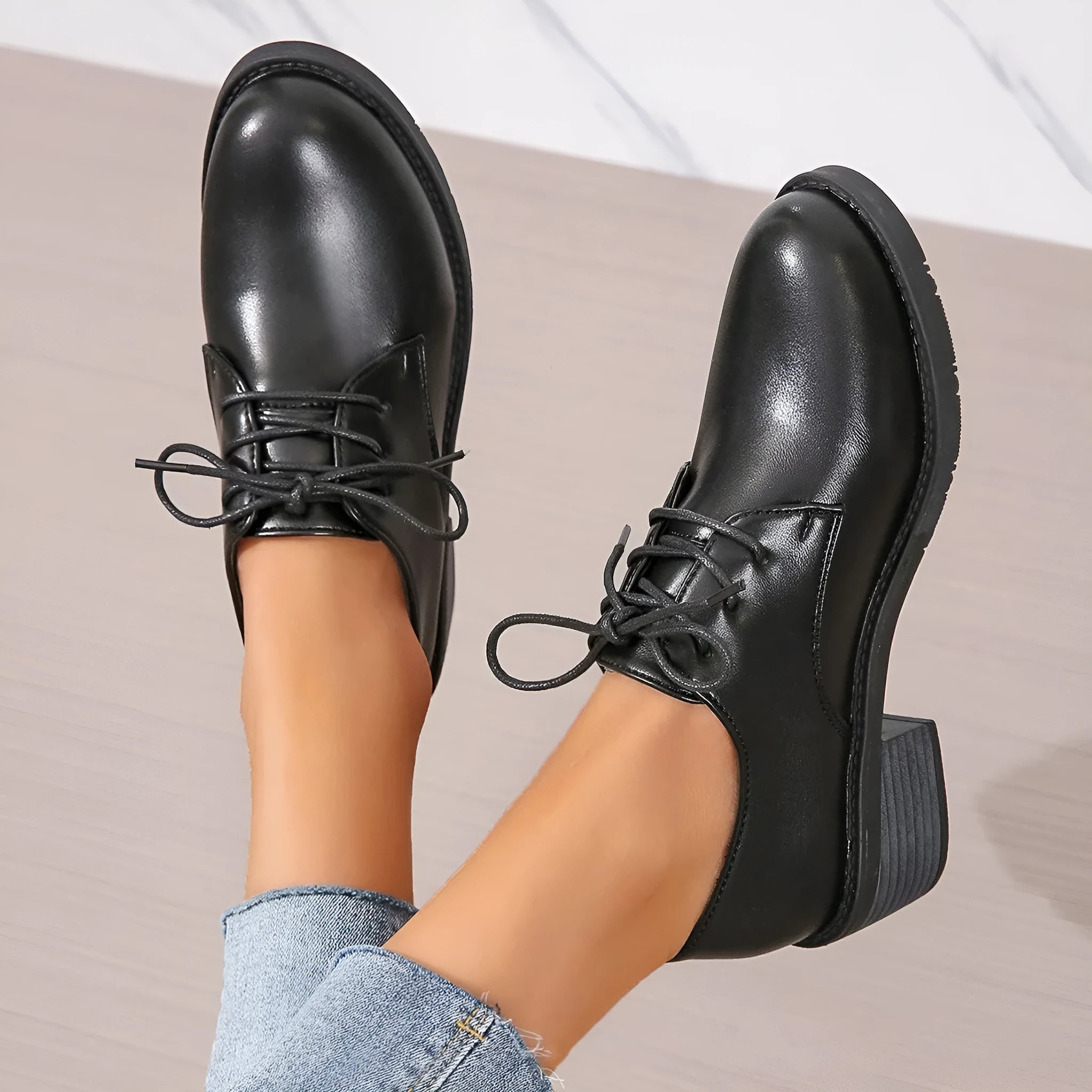Black women's work shoes with a chunky heel, round toe, and low top design on a rubber sole.