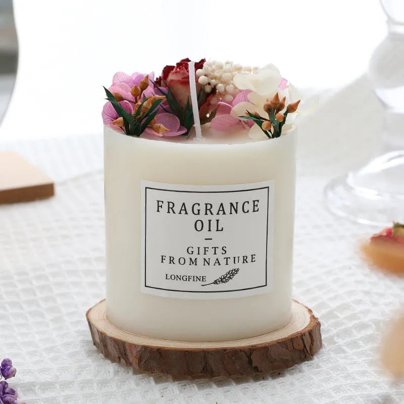 Decorative aromatherapy candle with dried flowers on a wood chip base, available in multiple scents.