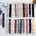 Woven nylon Apple Watch strap in multiple colours showing fabric texture and watch attachment