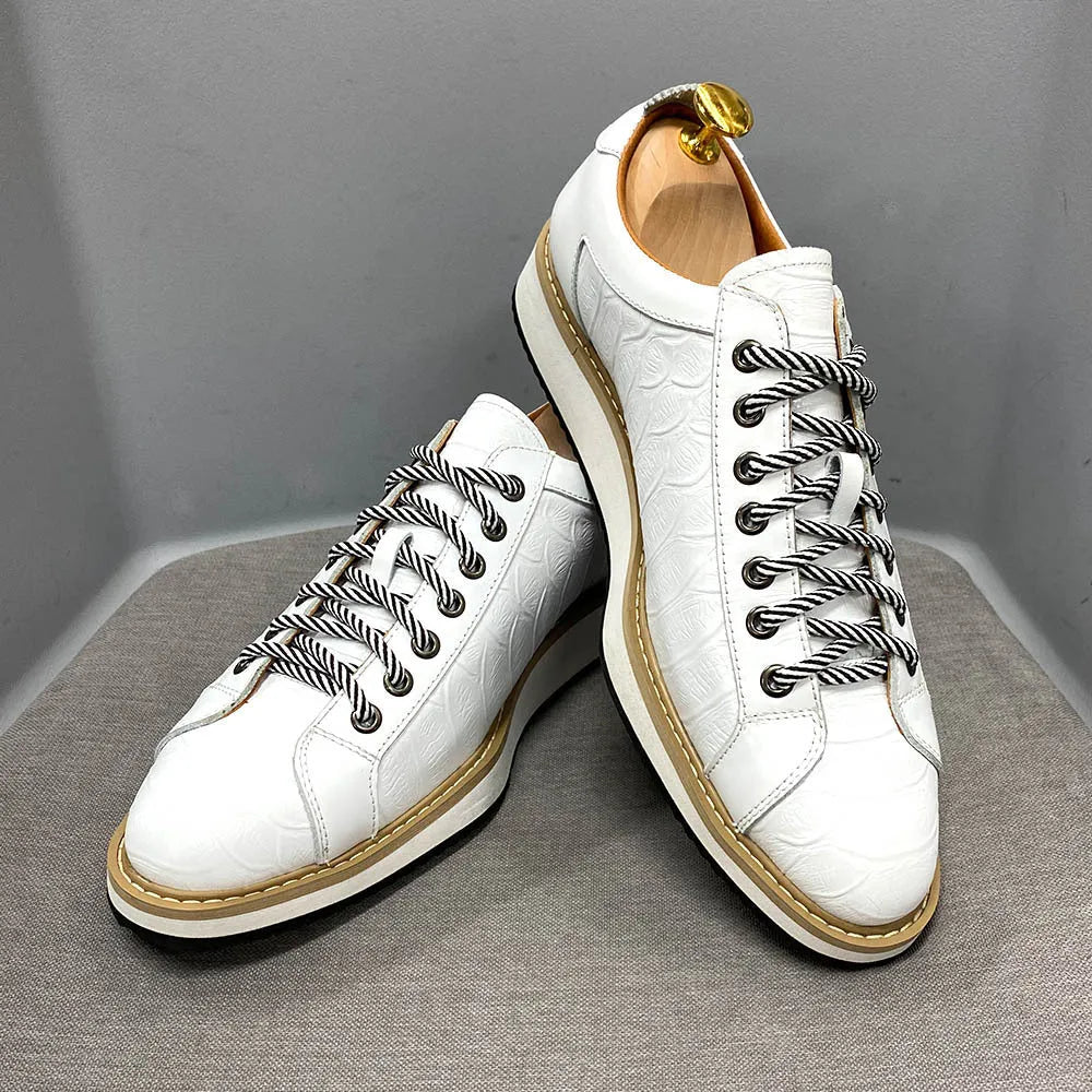 Men's low-top white shoes with embossed pattern texture, featuring lace-up front and microfiber lining.