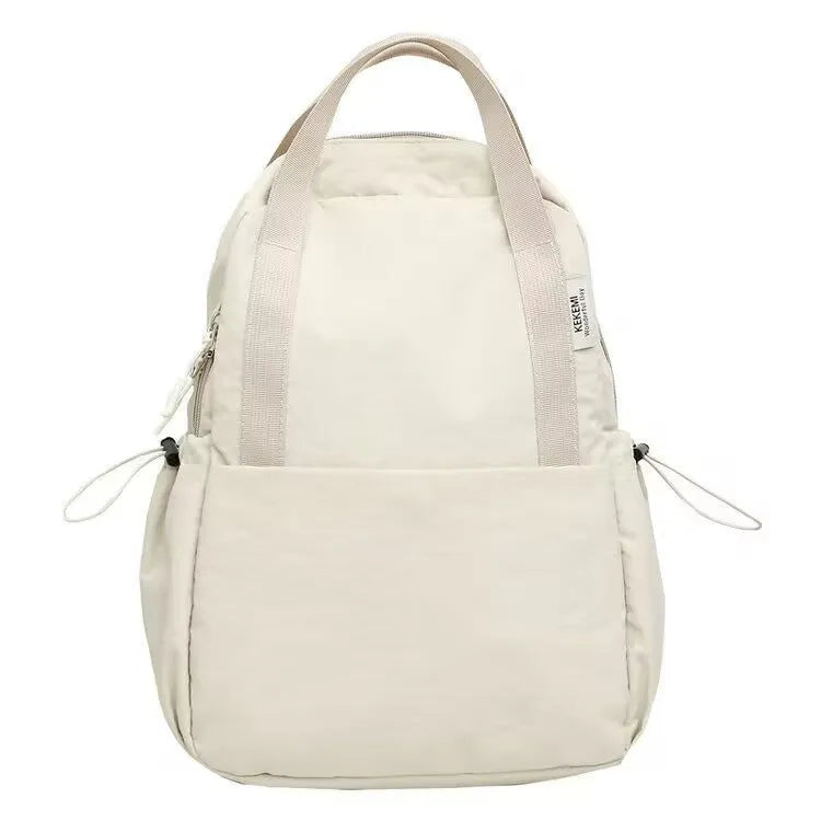 Solid colour nylon backpack in blue with curved straps and a lock, shown in a travel setting.