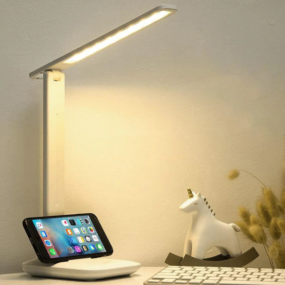 White USB rechargeable bedside lamp with touch dimming controls on a table.