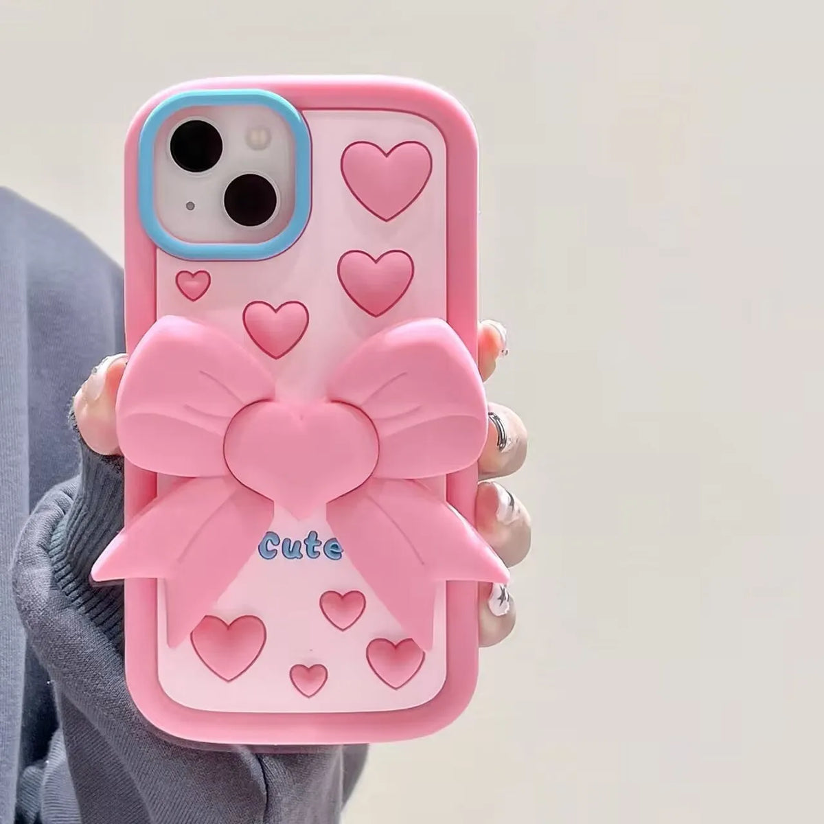 Pink 3D bow heart silicone phone case with hidden holder on iPhone, matte finish, Japanese Korean style design