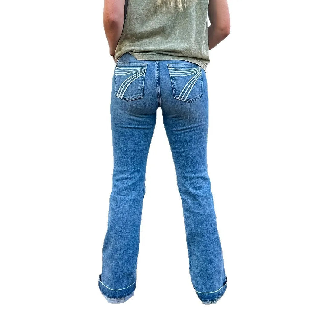 Slim fit blue embroidery jeans with slight flare and mid-waist rise on a neutral background.