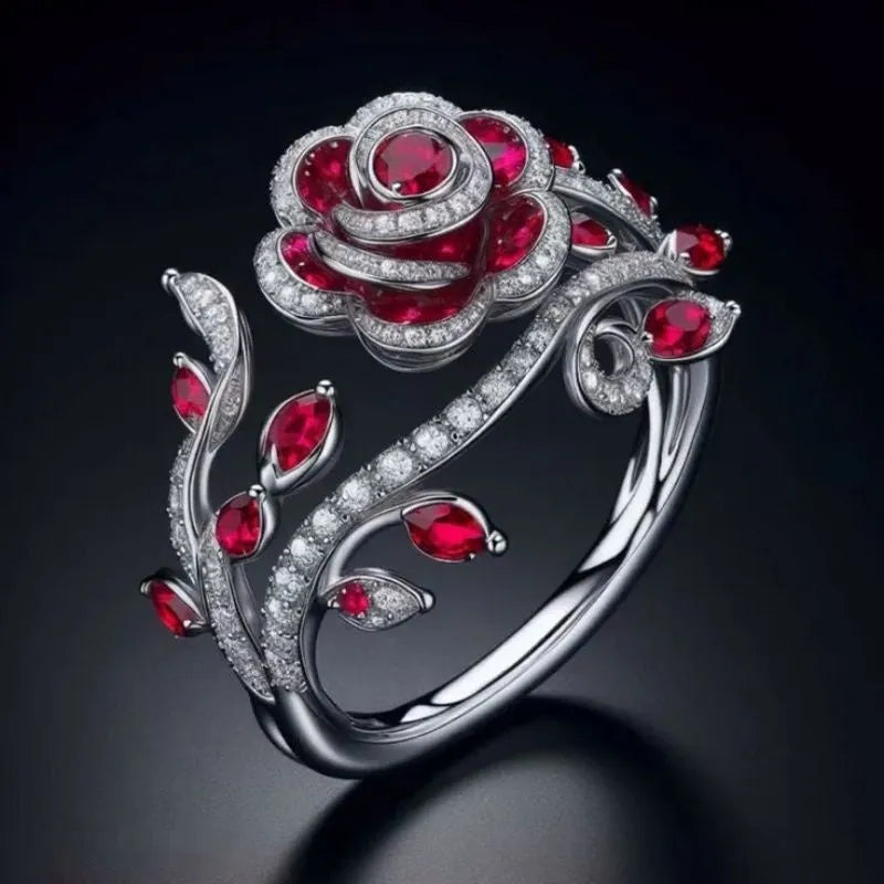 Silver ring with interwoven leaf pattern and red zircon stone