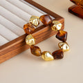 Vintage beaded amber blooming resin wide bracelet in retro style with electroplated alloy finish, gold colour