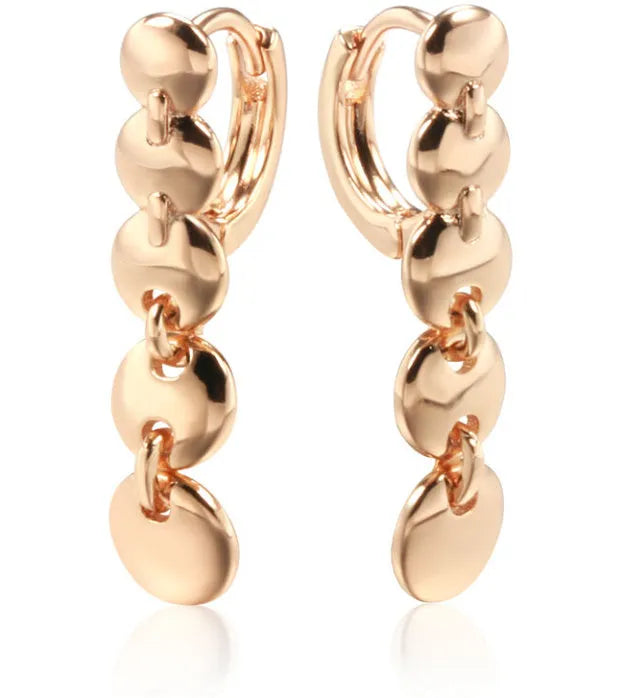 A pair of long, round circle-shaped retro earrings in a gold colour, made from woven copper