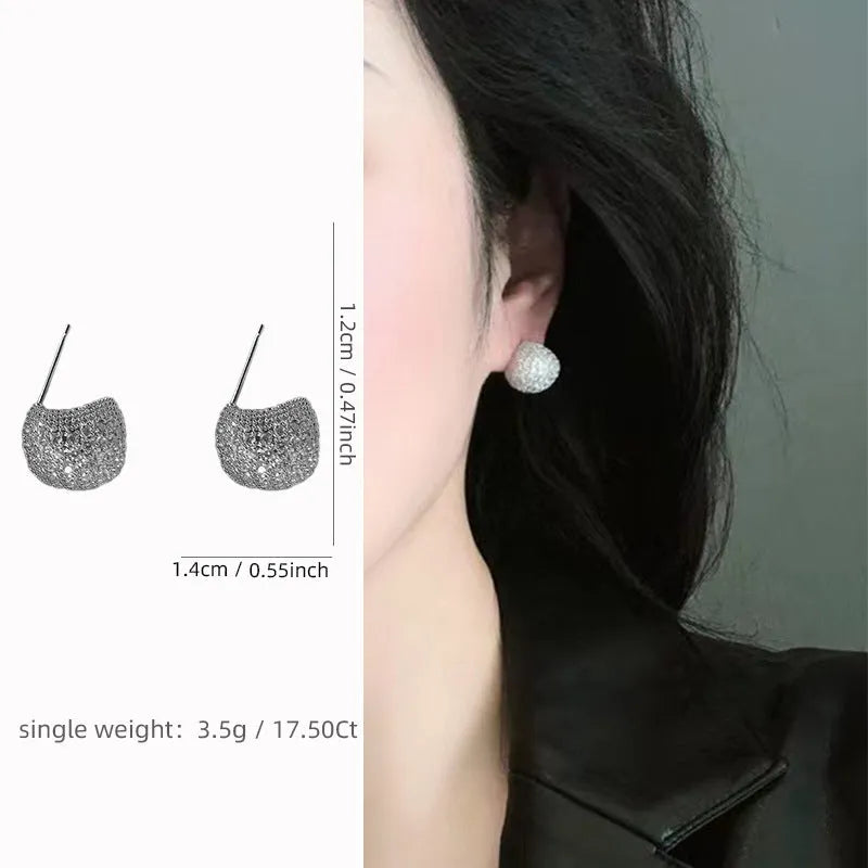 Women's drop-shaped clip earrings with full diamond elements and golden beans detailing