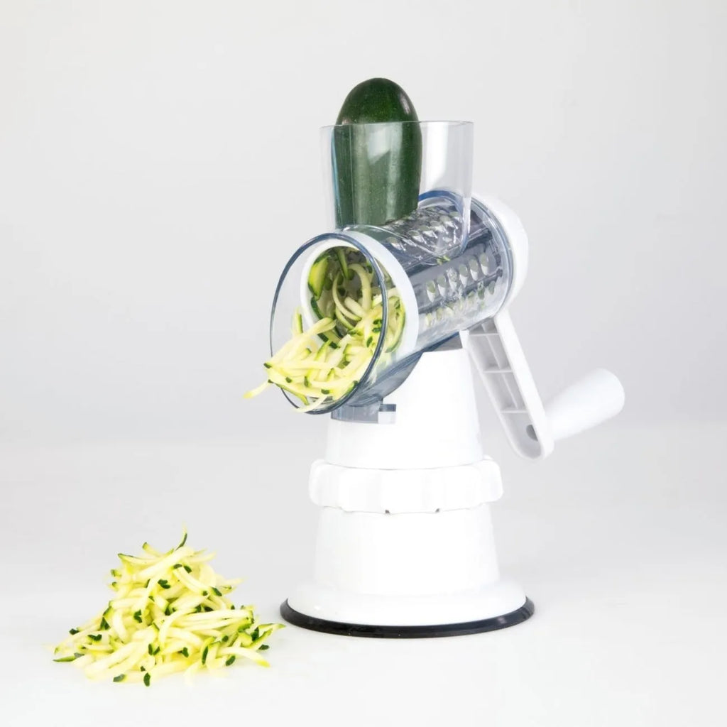 White 3-in-1 manual vegetable slicer with stainless steel blades on kitchen counter