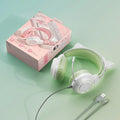 Pink cat ear esports earphones with protein cotton earmuffs and woven wire cable on a desk