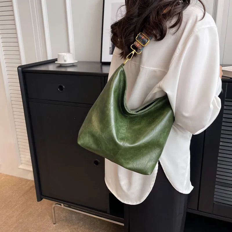 Retro bucket bag with wide shoulder strap, solid colour in beige, shown from front angle