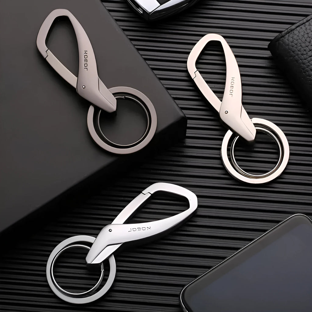 A black zinc alloy double-ring key chain holding a set of keys against a neutral background.