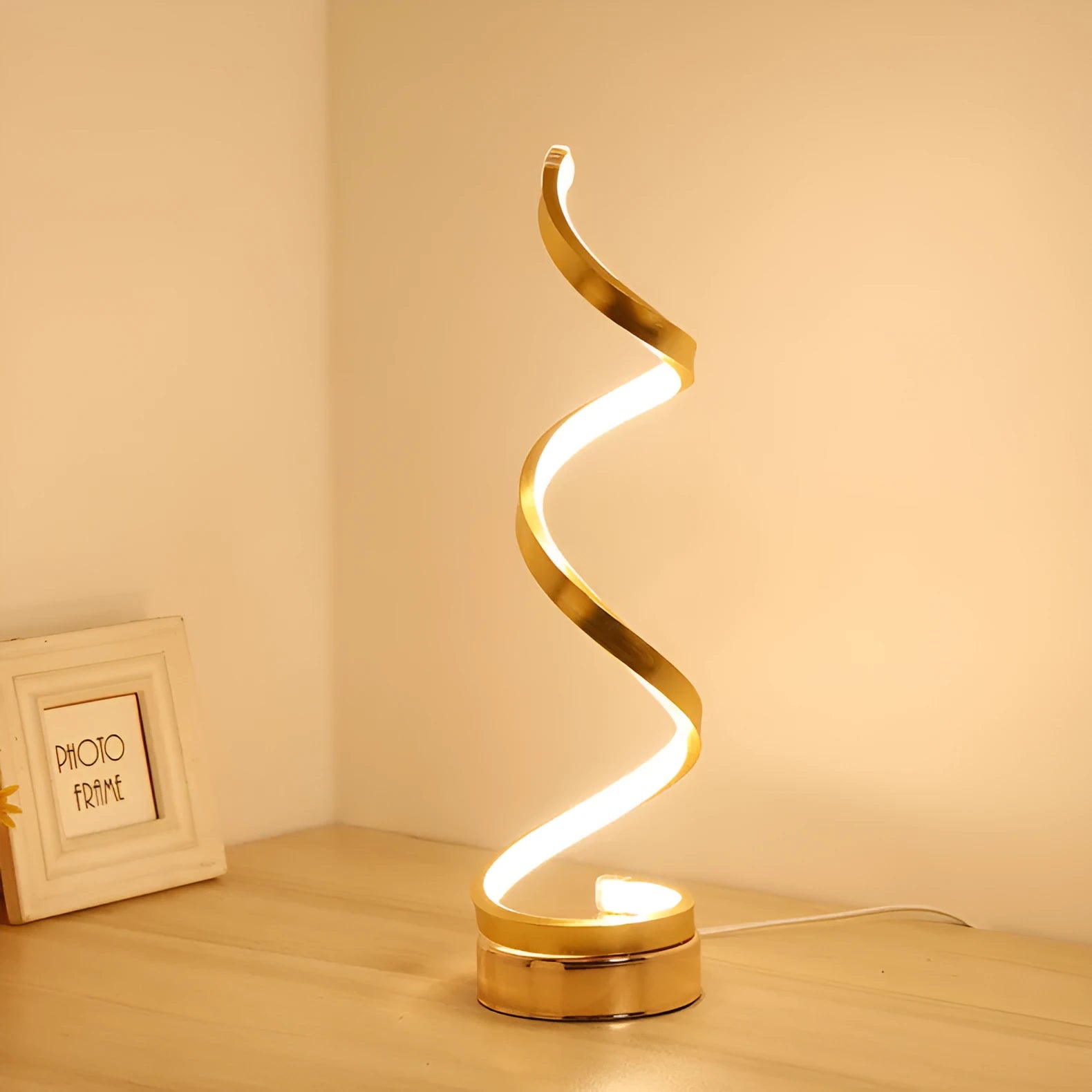 Minimalist black LED table lamp with aluminium shade on wooden desk