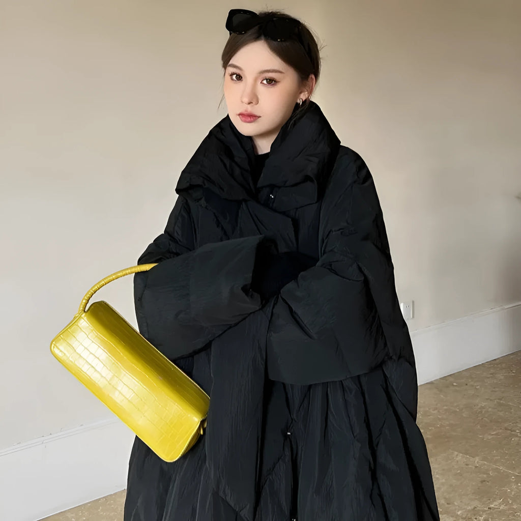 Women's large size mid-length loose fit winter coat with front zipper in black on a model