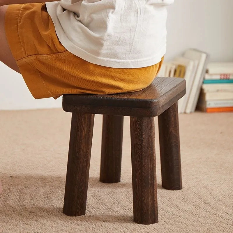 Solid wood distressed finish shoe changing stool with bracket legs.