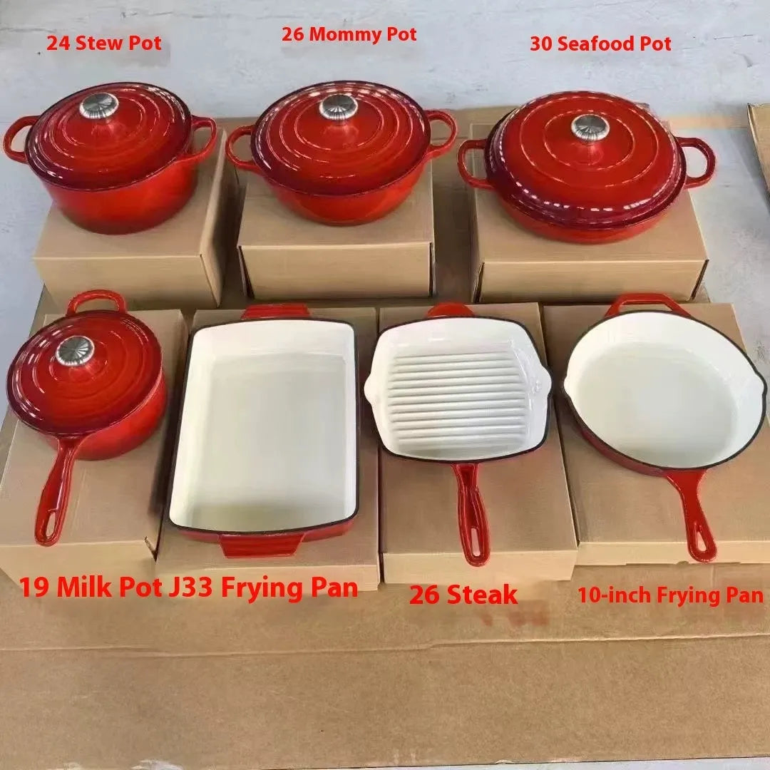 Cast iron enamel casserole set with frying pan and stew pot in light blue colour on a wooden table