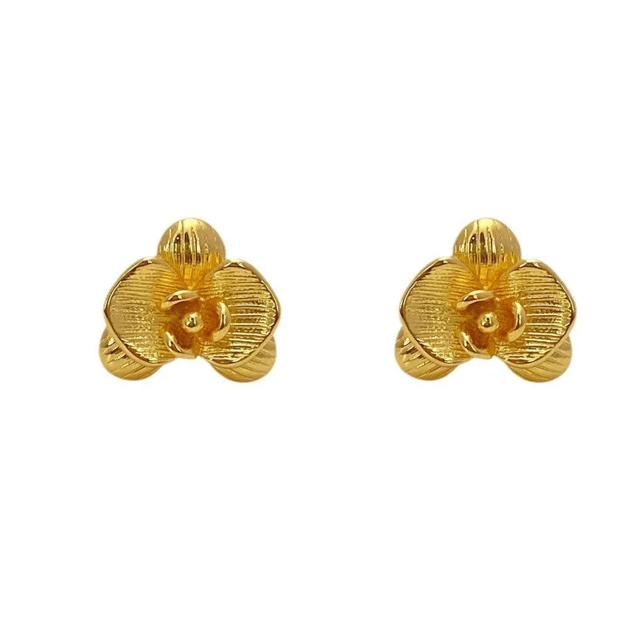 Women's retro flower earrings in copper with gold or silver electroplated finish showing petal detailing