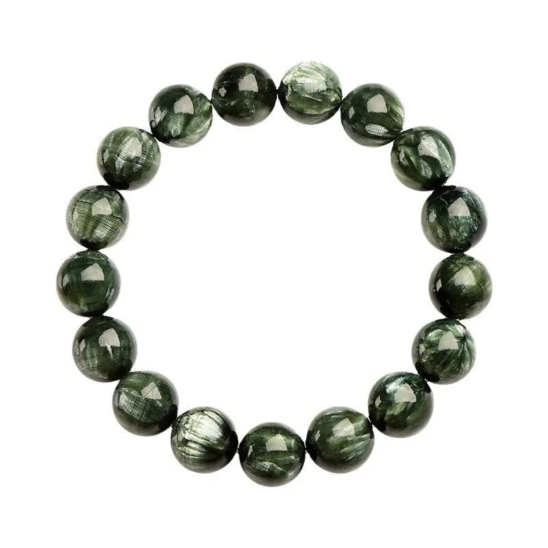 Close-up of a green dragon crystal bead bracelet with round geometry beads and a Ruyi charm.