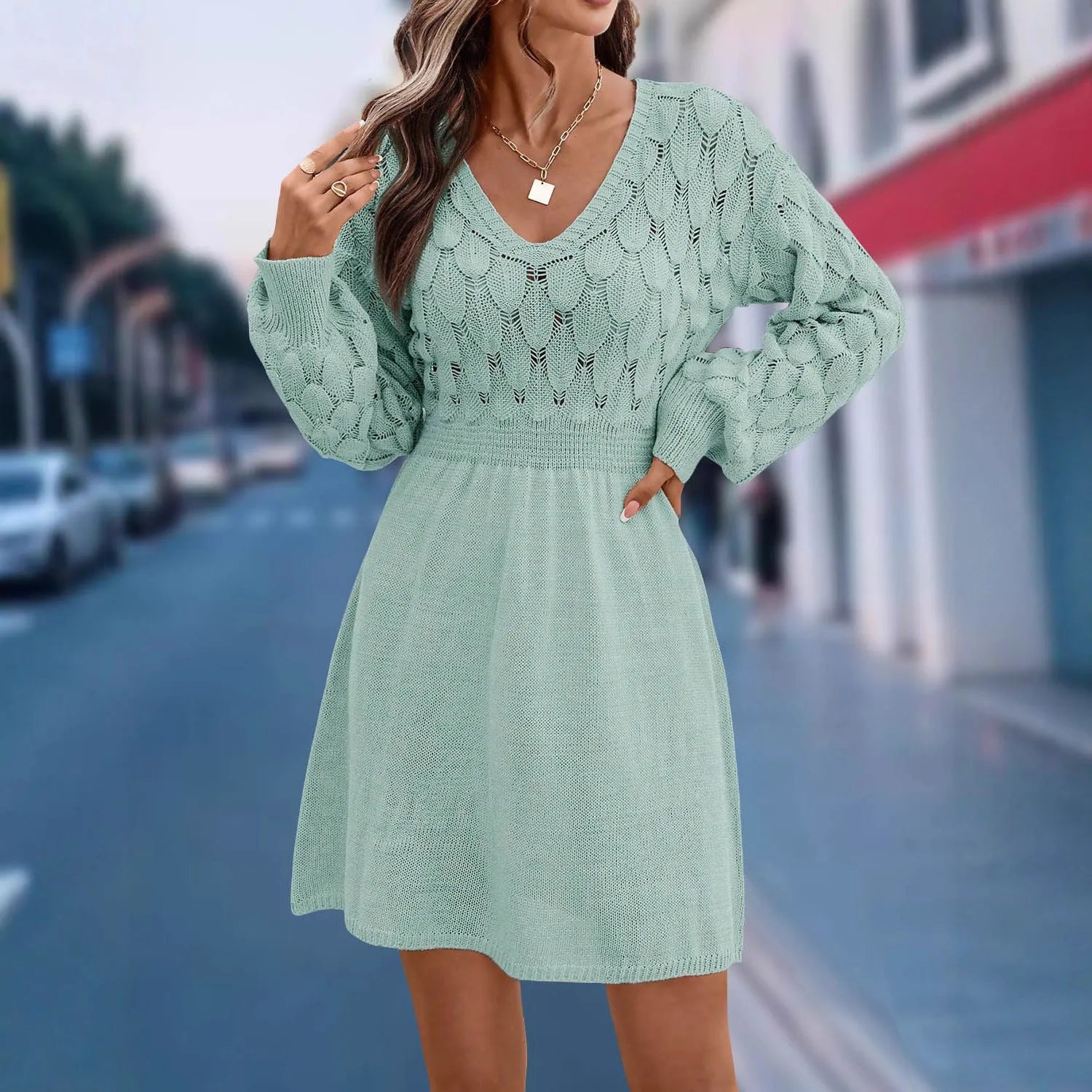 Retro ethnic style V-neck long sleeve dress in acrylic fabric on a hanger.