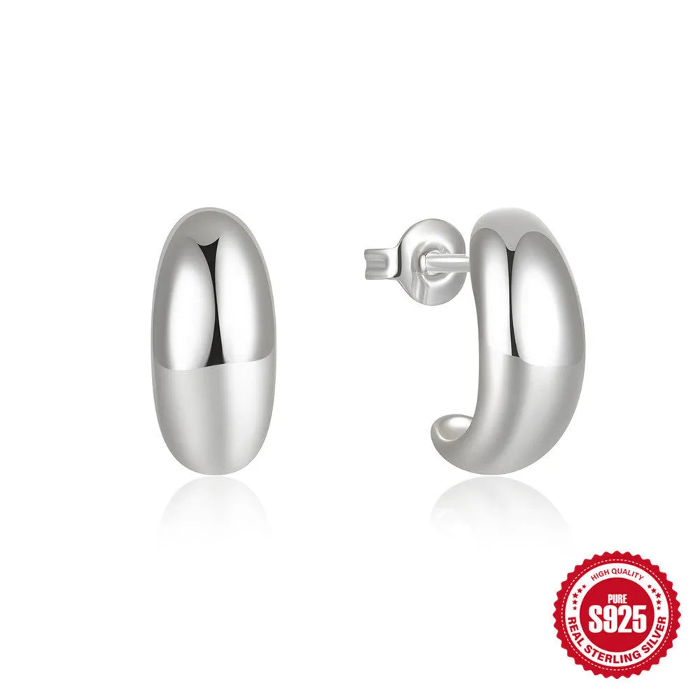A single C-shaped glossy stud earring made of sterling silver, shown in a gold colour finish.