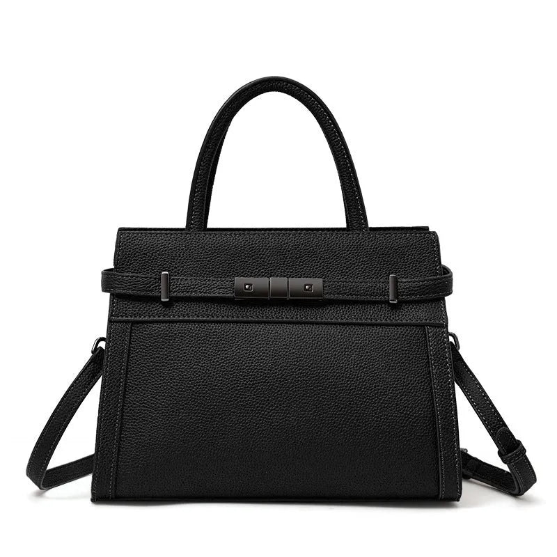 Women's black genuine leather crossbody clamshell handbag with multiple internal zip pockets.