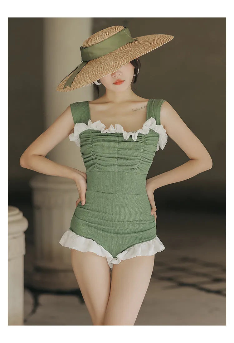 Black high-waisted one-piece swimsuit with triangle design on mannequin