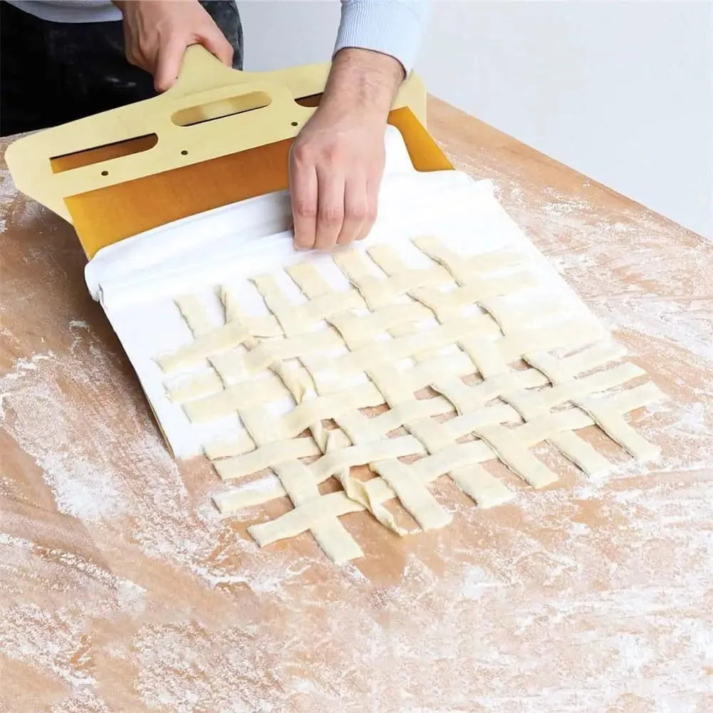 White plastic pizza transfer shovel on a kitchen counter, showing its flat board surface and handle with hanging hole.