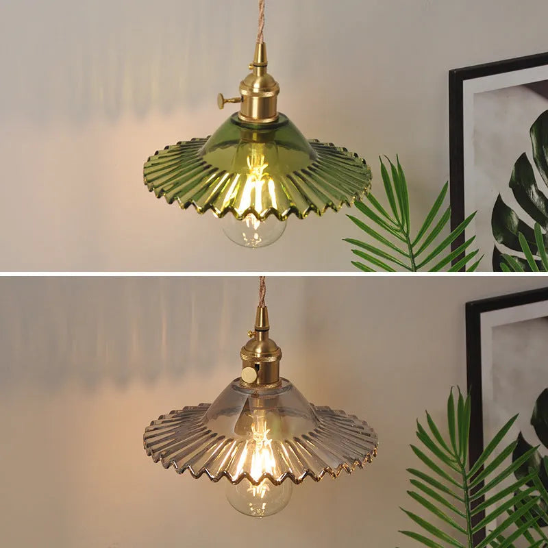 Retro brass-toned copper wall lamp with a white glass lotus shade mounted beside a bed.