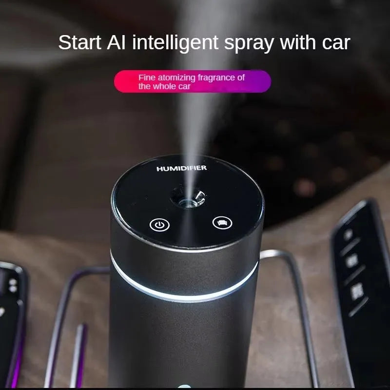 Black aluminium portable car humidifier and essential oil diffuser with USB cable on a desk.