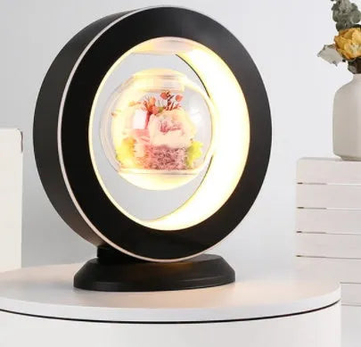 Pink floating heart LED levitation lamp with eternal flower on triangular base.