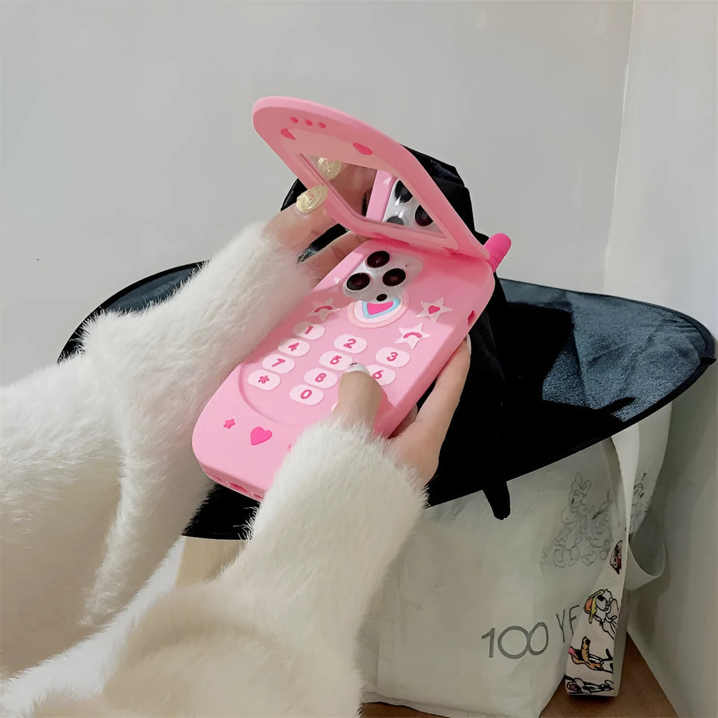 Light pink silicone flip phone case for iPhone with a built-in cosmetic mirror on the front.