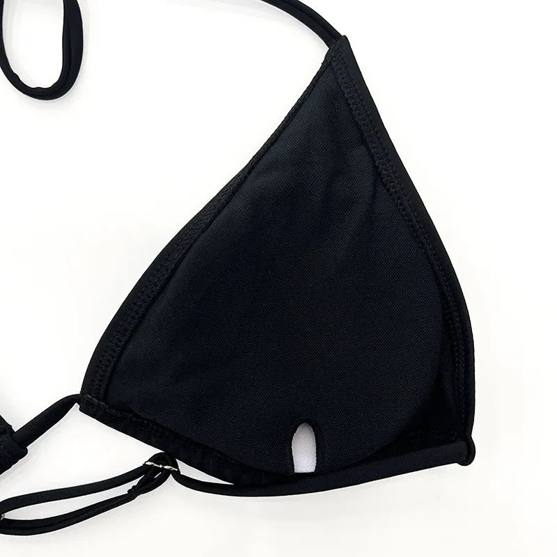 Black mesh four-piece women's bikini swimwear set with long sleeves on a hanger.