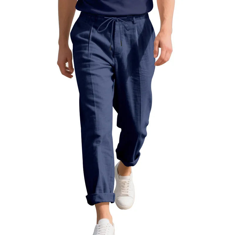 Men's light khaki linen casual trousers with drawstring waist on a hanger.