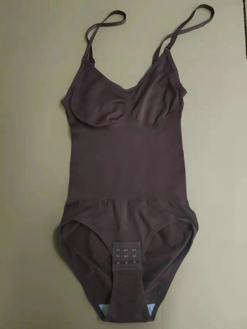 Plus size women's stretch sling one-piece shapewear in black nylon with hip lift and belly contracting functions