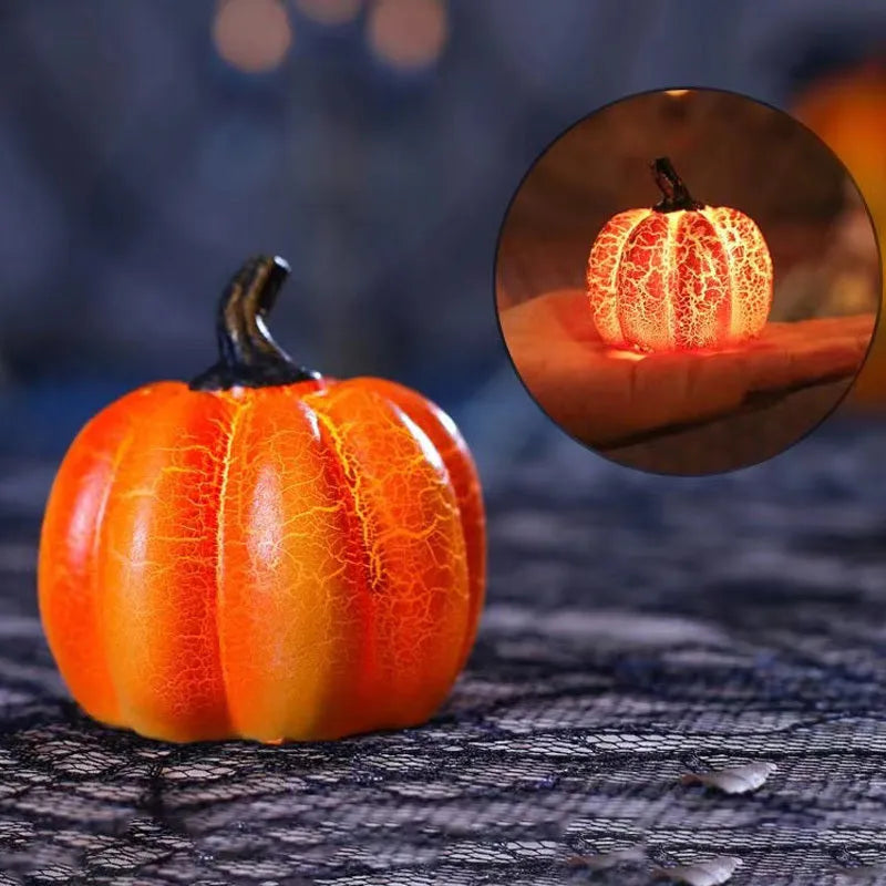 Three LED pumpkin lanterns in different sizes with realistic surface cracks and candle-like glow