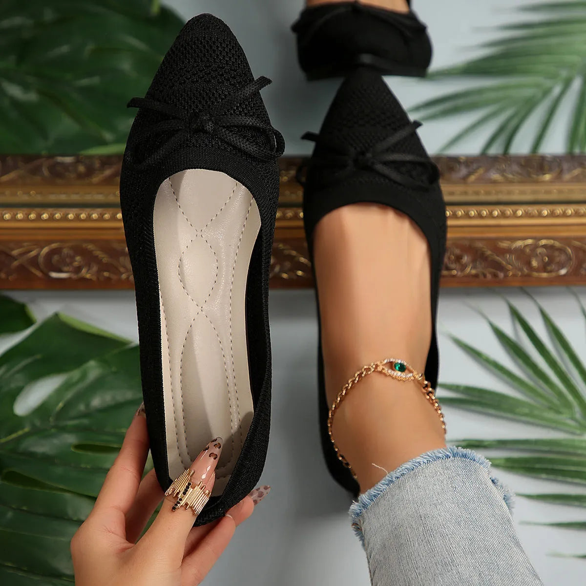 Women's blue knitted loafers with a bow detail and pointed toe on a flat rubber sole.