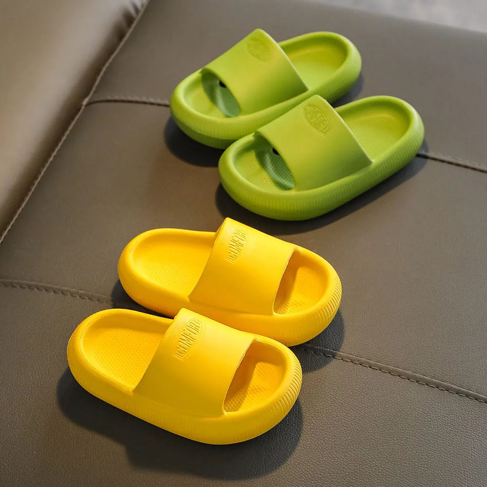 Colourful children's EVA slippers with textured non-slip sole, shown in blue, green, orange, pink, and yellow.