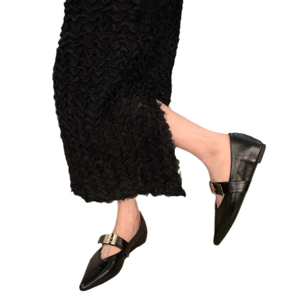 Women's black pointed toe Mary Jane buckle shoes with a low flat rubber sole.
