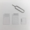 Four-in-one SIM restore kit showing three plastic SIM adapters and a metal pickup pin
