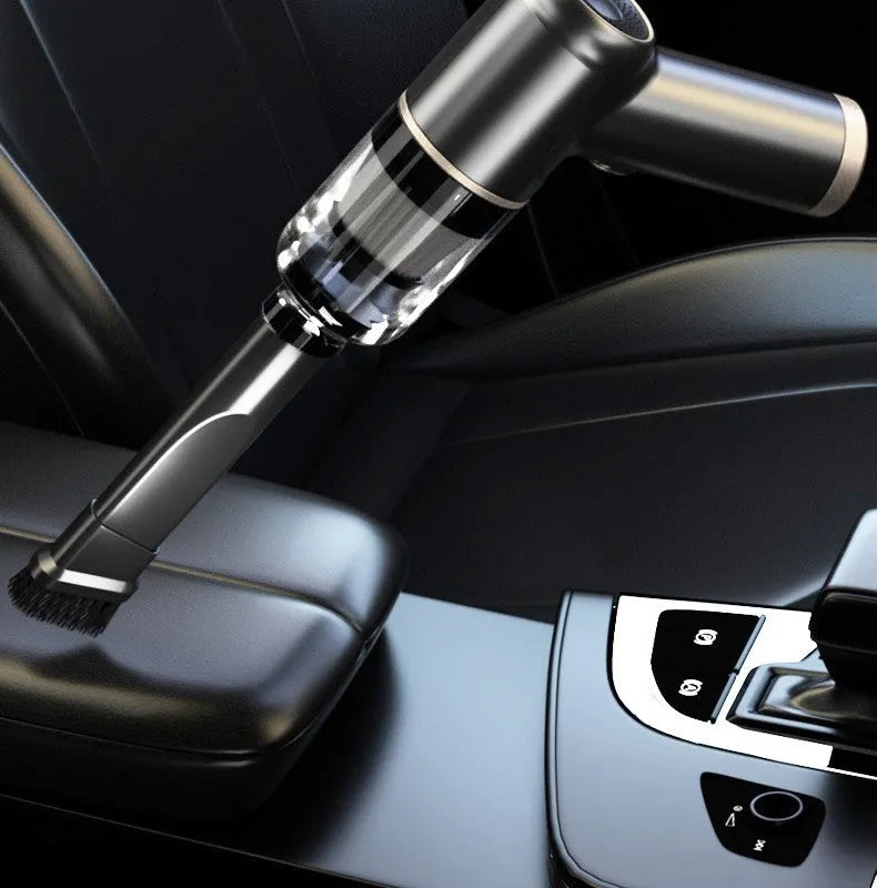 Black wireless handheld car vacuum cleaner with assorted nozzles and a USB cable