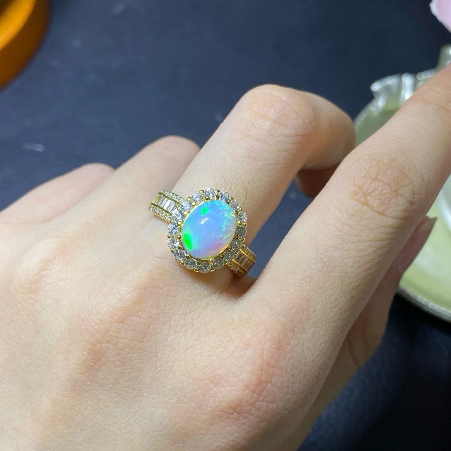 Handmade adjustable silver ring with a natural opal, shown in rose gold plating.