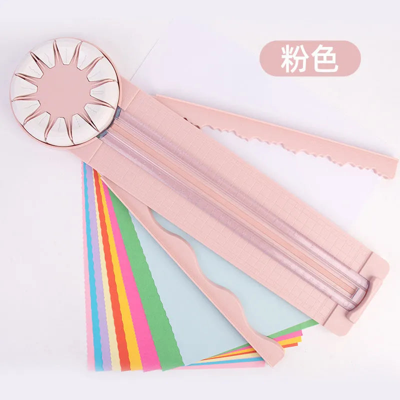 A pink plastic 12-in-1 multifunctional paper cutter with a dotted design on a flat surface.