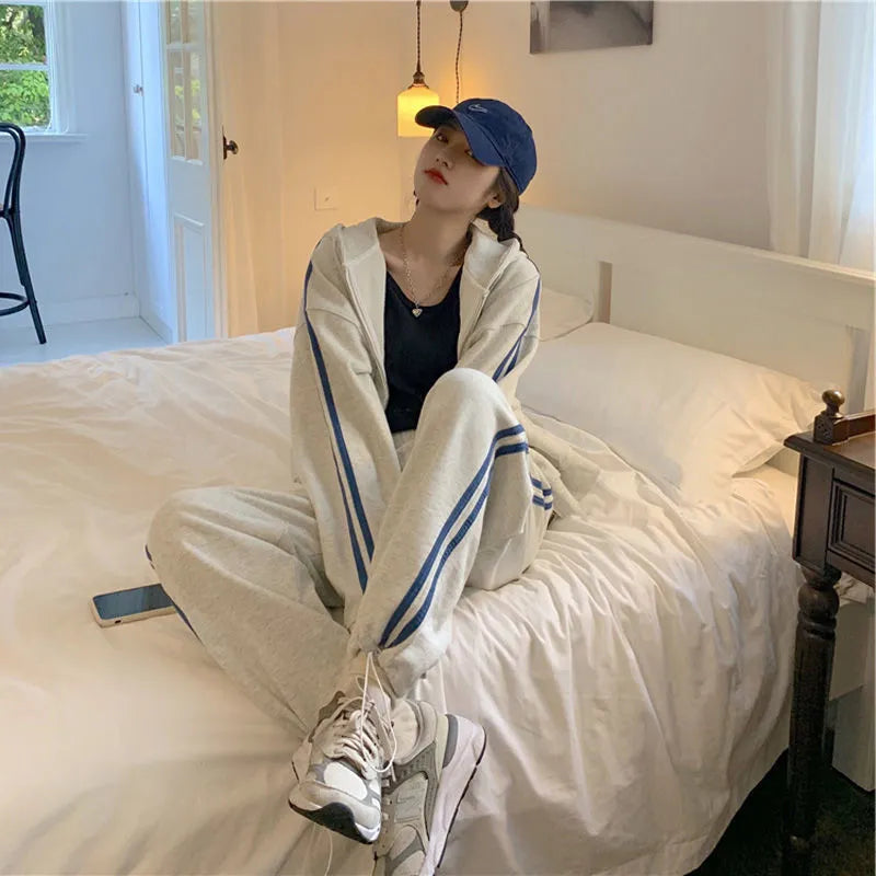 Women's two-piece striped polyester tracksuit set, light gray, top and trousers on plain background