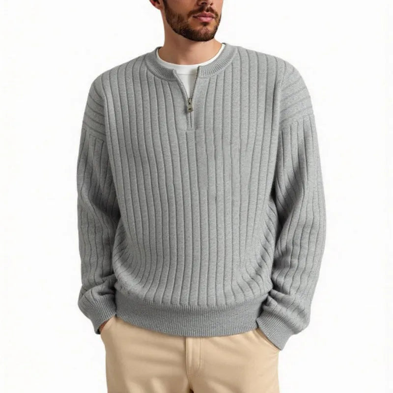 Man wearing a grey half-zip loose fit knitted sweater pullover.