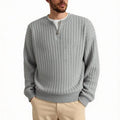 Man wearing a grey half-zip loose fit knitted sweater pullover.