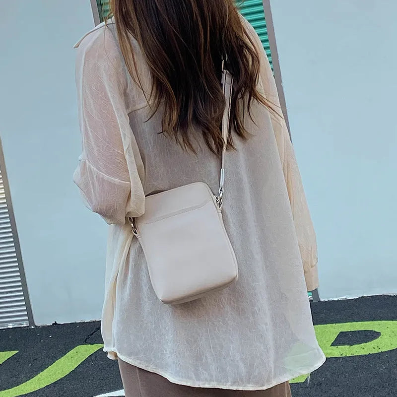 Small solid colour crossbody shoulder bag for mobile phones in beige.
